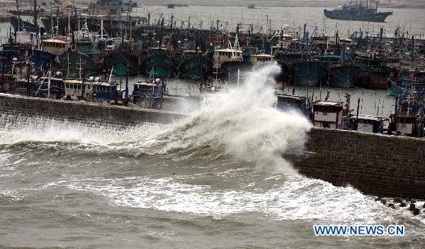 Fishing boats get shelter at a harbor as Typhoon Megi, possibly the strongest to hit China this year, draws near, in Hui'an County of Quanzhou City, southeast China's Fujian Province, Oct. 22, 2010. 
