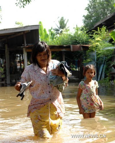 A Thai woman and her daughter walk in water in Ayutthaya, about 80 kilometers north to Bangkok, on Oct. 22. 2010. 
