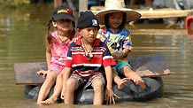 Children row a tyre in water in Ayutthaya, about 80 kilometers north to Bangkok, on Oct. 22. 2010.