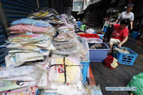 People clean their belongings in Su'ao, southeast China's Taiwan, on Oct. 24, 2010.
