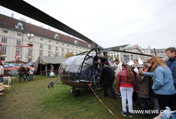 Citizens visit the helicopter used by the Austrian Federal Army during the Austrian National Day celebration in Vienna, capital of Austria, Oct. 26, 2010. 