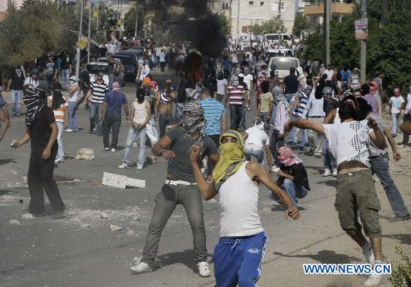 A protester throws stones during clashes in Umm el-Fahm Oct. 27, 2010. 