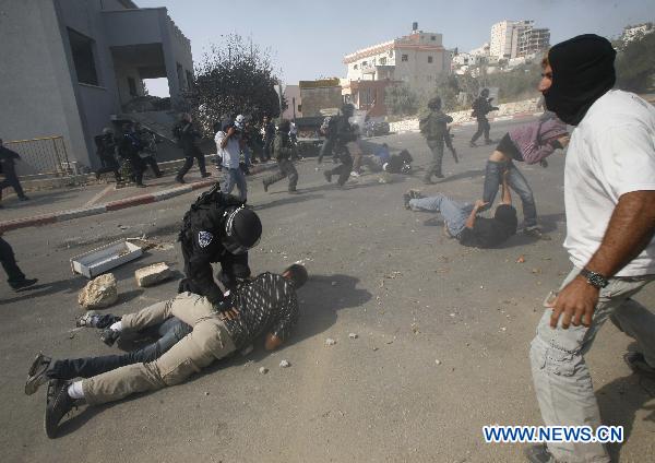 Undercover Israeli police officers restrain protesters during clashes in Umm el-Fahm Oct. 27, 2010. 