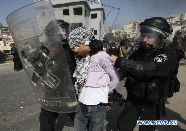 Undercover Israeli police officers restrain protesters during clashes in Umm el-Fahm Oct. 27, 2010. 
