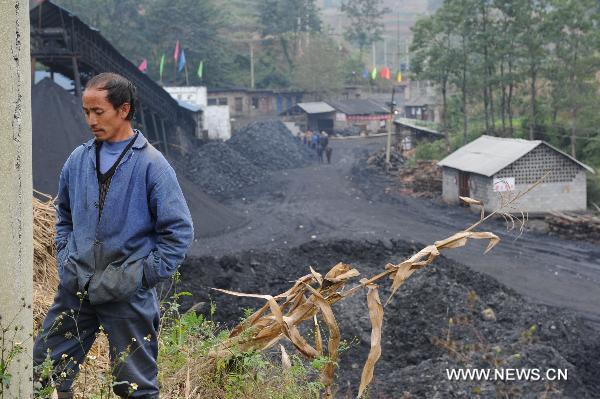 A worker stands outside the flooded Dapo coal mine in Machang Town of Puding County under Anshun City, southwest China&apos;s Guizhou Province, Oct. 28, 2010.