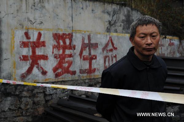 A worker stands outside the flooded Dapo coal mine in Machang Town of Puding County under Anshun City, southwest China&apos;s Guizhou Province, Oct. 28, 2010. 