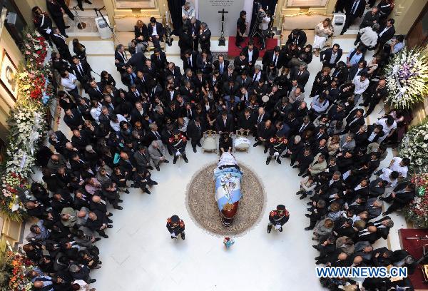 In this handout image provided by the Argentine presidency, Argentine President Cristina Fernandez de Kirchner sits in front of the coffin of her late husband, former President Nestor Kirchner, during his wake in the Presidential Palace in Buenos Aires, Argentina, on Oct. 28, 2010.