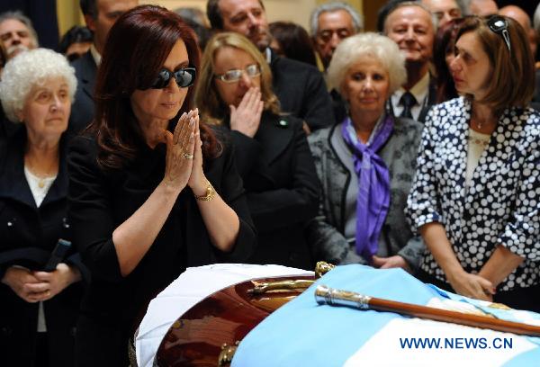 In this handout image provided by the Argentine presidency, Argentine President Cristina Fernandez de Kirchner stands in front of the coffin of her late husband, former President Nestor Kirchner, during his wake in the Presidential Palace in Buenos Aires, Argentina, on Oct. 28, 2010.