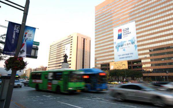 Cars go past posters promoting the forthcoming G20 Seoul Summit at the Gwanghuamun plaza in Seoul, capital of South Korea, on Nov. 1, 2010. The summit will be held from Nov. 11 to 12. 