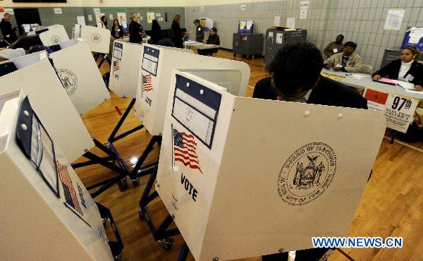 People fill in their ballots at a polling station in Manhattan of New York, the United States, Nov. 2, 2010, the US Midterm Election Day. 