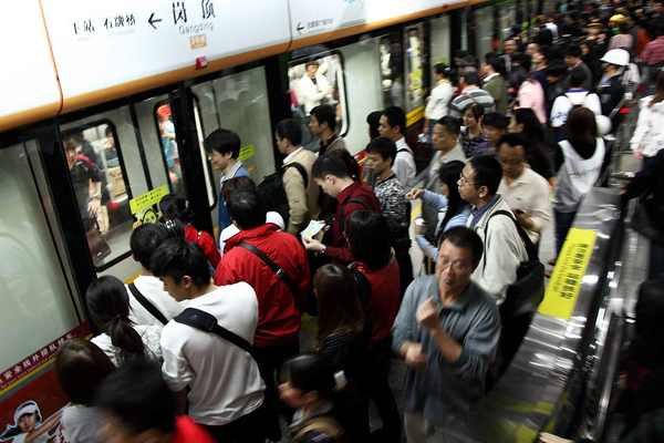 Passengers at Gangding subway station in Guangzhou on Monday.