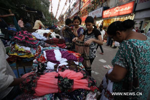 People do some shopping at a market for festive decorations in New Delhi, capital of India, Nov. 2, 2010, prior to the Diwali Festival. Diwali, or festival of lights is the biggest Hindu festival which will be celebrated on Nov. 5 this year.