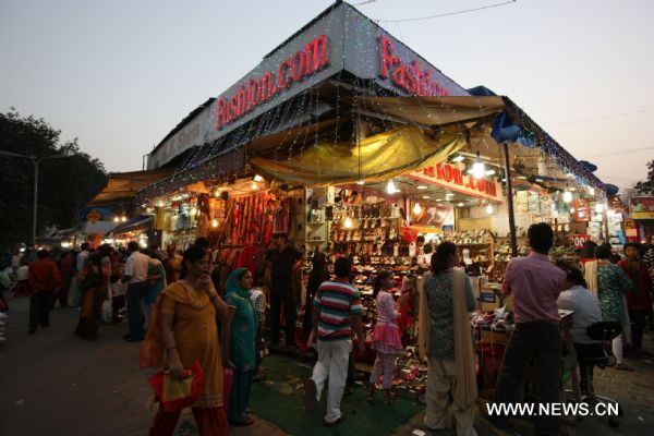 People do some shopping at a market for festive decorations in New Delhi, capital of India, Nov. 2, 2010, prior to the Diwali Festival. Diwali, or festival of lights is the biggest Hindu festival which will be celebrated on Nov. 5 this year. 