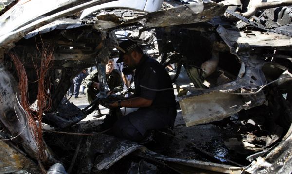 Palestinian security members inspect explosion site in Gaza City, on Nov. 3, 2010. 