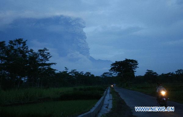 A motorist rides on a road at Klaten village as Merapi volcano spewed lava and smoke again, near the ancient city of Yogyakarta, Indonesia, on Nov. 4, 2010.