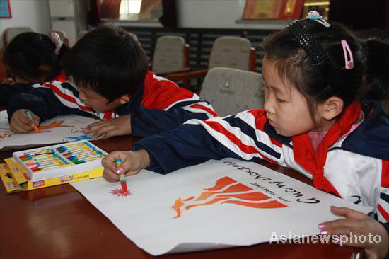 Primary school students in Guangpin, north China's Hebei Province, work hard at drawing the Guangzhou Asian Games emblem on Nov 4, 2010.