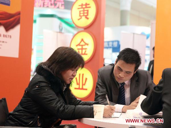 A visitor consults for gold investment products at the Sixth Beijing International Finance Expo in Beijing, capital of China, Nov. 4, 2010.