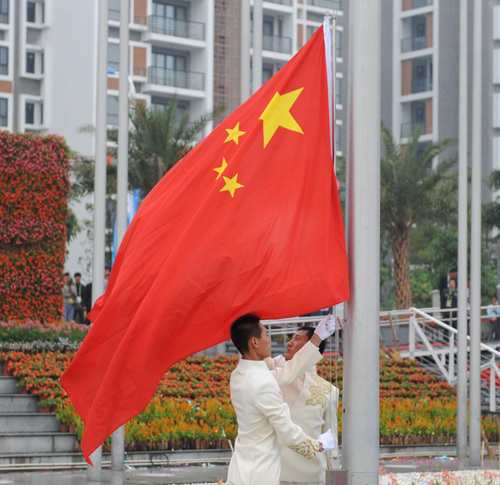 China's national flag is raised as the Asian Games Athletes Village officially opens and the Chinese delegation enters the village in Guangzhou, Nov 5, 2010.