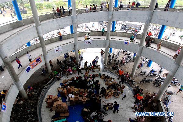 Refugees stay in the Maguwoharjo Stadium, a temporary refuge center set up by local government after Volcano Merapi&apos;s latest re-eruption, in Yogyagarta, Central Java of Indonesia, Nov. 5, 2010