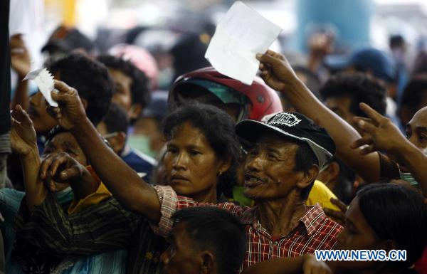 Refugees reach out to get relief materials in the Maguwoharjo Stadium, a temporary refuge center set up by local government after Volcano Merapi&apos;s latest re-eruption, in Yogyagarta, Central Java of Indonesia, Nov. 5, 2010. 