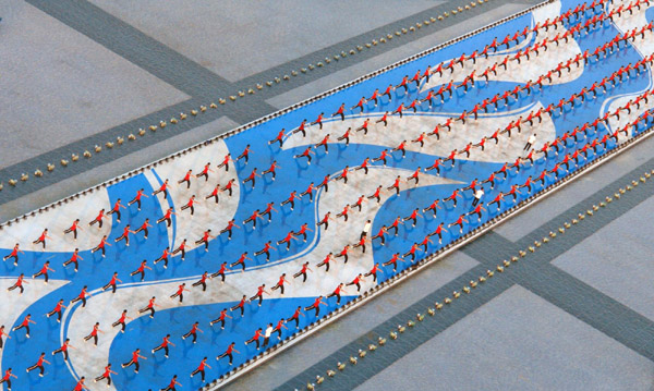 Students from Shaolin Tagou Martial Arts School practice on a square in Guangzhou, south China's Guangdong Province, Nov 7, 2010. 