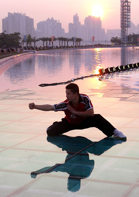 A student from Shaolin Tagou Martial Arts School practices on a square in Guangzhou, south China's Guangdong Province, Nov 7, 2010. 