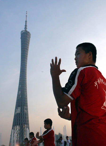 Students from Shaolin Tagou Martial Arts School practice on a square in Guangzhou, south China's Guangdong Province, Nov 7, 2010. 