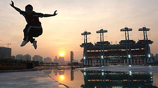 A student from Shaolin Tagou Martial Arts School practices on a square in Guangzhou, south China's Guangdong Province, Nov 7, 2010.