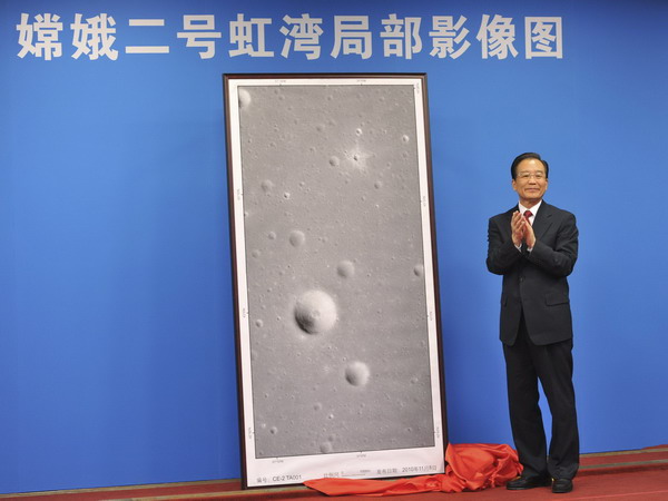 Chinese Premier Wen Jiabao unveils pictures of the moon's Sinus Iridum, or Bay of Rainbows, marking the success of China's Chang'e-2 lunar probe mission.