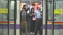 The photo taken on Nov. 8, 2010 shows commuters aboard a tube train in Guangzhou, south China's Guangdong Province.