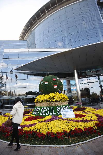 A passer-by walks past the Convention and Exhibition Center (COEX) in Seoul, capital of the Republic of Korea (ROK), Nov. 9, 2010.