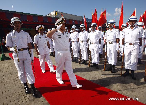 Bao Yuping (C Front), commander of the Chinese Navy hospital ship 'Peace Ark', receives flowers in southeast Bangladesh's Chittagong, on Nov. 9, 2010