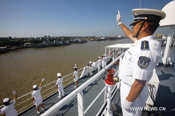 Bao Yuping (C Front), commander of the Chinese Navy hospital ship 'Peace Ark', receives flowers in southeast Bangladesh's Chittagong, on Nov. 9, 2010