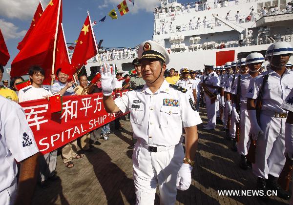 Bao Yuping (C Front), commander of the Chinese Navy hospital ship 'Peace Ark', receives flowers in southeast Bangladesh's Chittagong, on Nov. 9, 2010