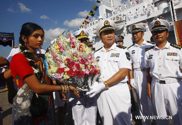 Bao Yuping (C Front), commander of the Chinese Navy hospital ship 'Peace Ark', receives flowers in southeast Bangladesh's Chittagong, on Nov. 9, 2010