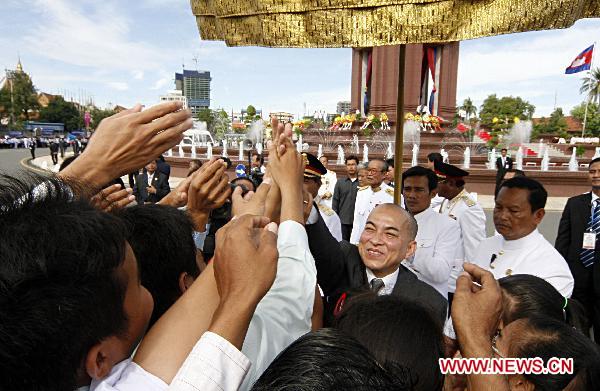 Cambodian King Norodom Sihamoni inspects the guard of honour during a ceremony to celebrate the 57th anniversary of independence of Cambodia in Phnom Penh, on Nov. 9, 2010.