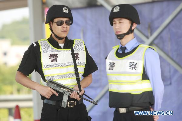 Policemen guard at a highway entrance to Guangzhou, capital of south China&apos;s Guangdong Province, Nov. 10, 2010. 