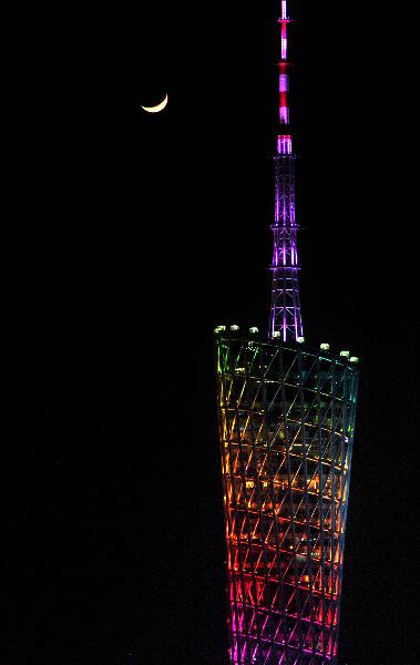 Picture taken on Nov. 10, 2010 shows the crescent and the Guangzhou Tower in Guangzhou, south China&apos;s Guangdong Province. The 16th Asian Games would run in Guangzhou from Nov. 12 to 27. 