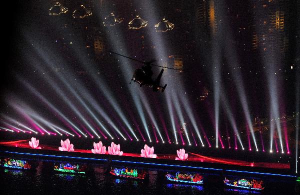 Picture taken on Nov. 10, 2010 shows a helicopter flying over the illuminated Zhujiang River in Guangzhou, south China&apos;s Guangdong Province. The 16th Asian Games would run in Guangzhou from Nov. 12 to 27.