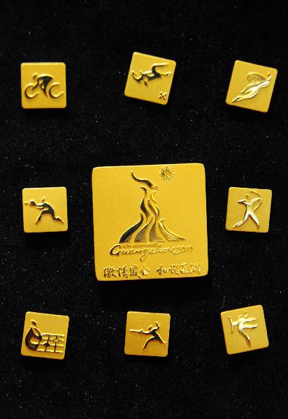 The Complete Lapel Pin Collection for the 16th Asian Games is released in Guangzhou, south China's Guangdong Province, Nov. 10, 2010.