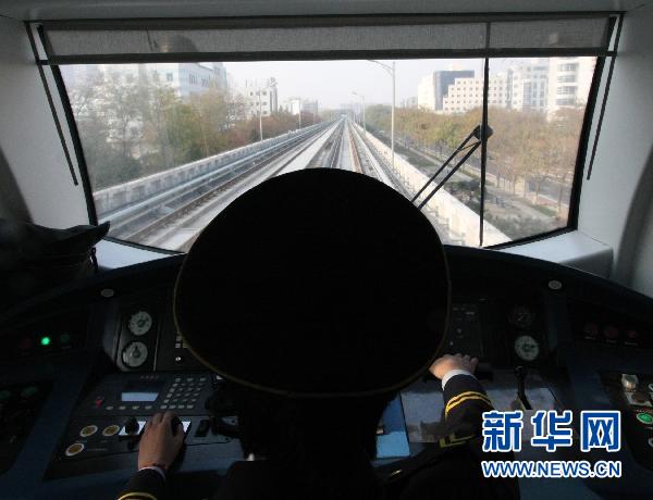 The view from the driver&apos;s cab as a train speeds along outdoor track during a trial run of the new Yizhuang subway line in Beijing. 