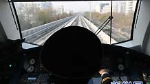 The view from the driver's cab as a train speeds along outdoor track during a trial run of the new Yizhuang subway line in Beijing.
