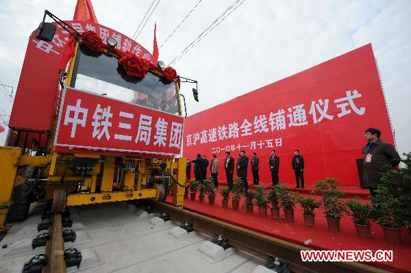 Workers operate machine to lay the last track of the Beijing-Shanghai high-speed railway in Bengbu City, east China's Anhui Province, Nov. 15, 2010. 