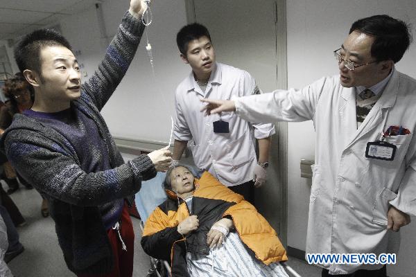 An injured citizen is sent to Jing'an District Centre Hospital in Shanghai, east China, Nov. 15, 2010. 
