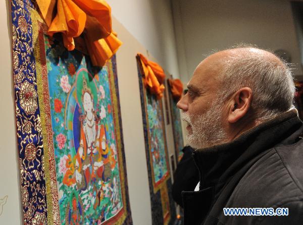A visitor looks at the Thangka show during the Week of the 2010 China Tibetan Culture in Madrid, Spain, Nov. 15, 2010. 