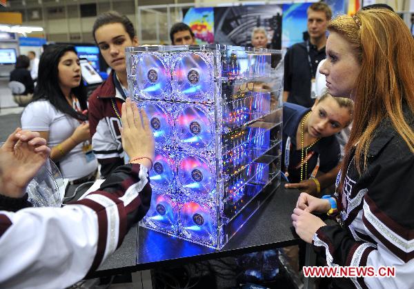 Students visit a 200 node &apos;Strong Box&apos; Strong ARM Processor during the supercomputing exhibition, part of the ongoing Supercomputing Conference (SC10), in New Orleans, Louisiana, the United States, Nov. 16, 2010. 