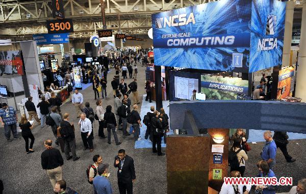 People tour around the supercomputing exhibition, part of the ongoing Supercomputing Conference (SC10), in New Orleans, Louisiana, the United States, Nov. 16, 2010. 