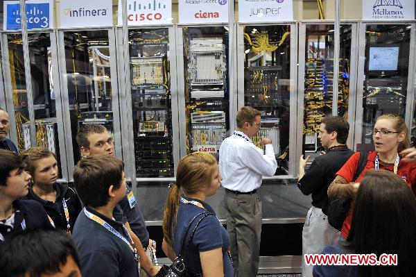 Students visit super computing systems during the supercomputing exhibition, part of the ongoing Supercomputing Conference (SC10), in New Orleans, Louisiana, the United States, Nov. 16, 2010.