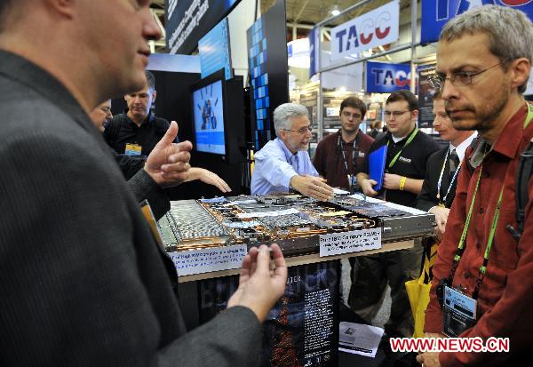 People visit an IBM supercumputing system during the supercomputing exhibition, part of the ongoing Supercomputing Conference (SC10), in New Orleans, Louisiana, the United States, Nov. 16, 2010. 
