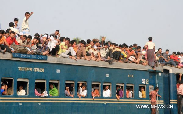 People stay on the rooftop of a homebound train in Dhaka, capital of Bangladesh on Nov. 16, 2010. Millions of Dhaka dwellers have already started leaving the city to celebrate Eid-ul-Azha, also known as the Eid of animal sacrifice, which will be celebrated on Nov. 17.